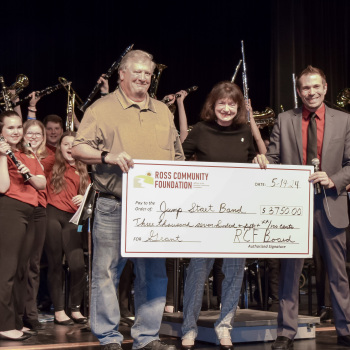 Group holding giant check